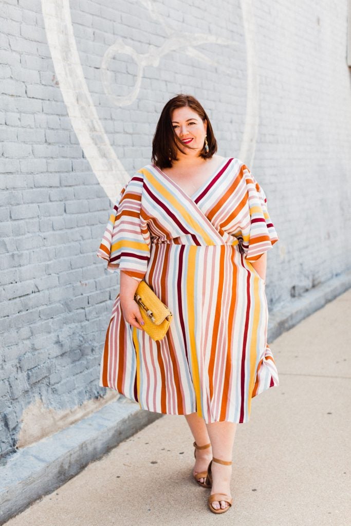 Plus size blogger Authentically Emmie in a striped dress from ELOQUII