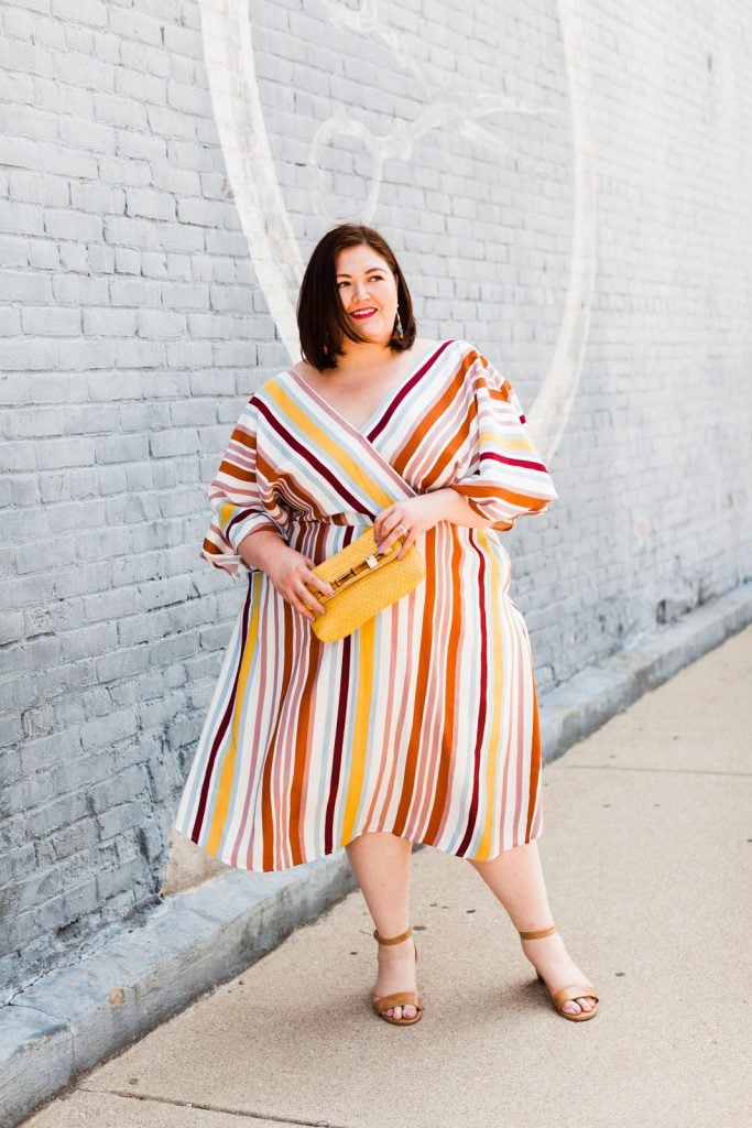 Plus size blogger Authentically Emmie in a striped dress from ELOQUII