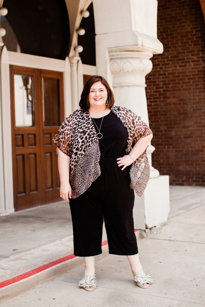 Plus size fashion blogger Authentically Emmie in a Catherines jumpsuit with leopard kimono