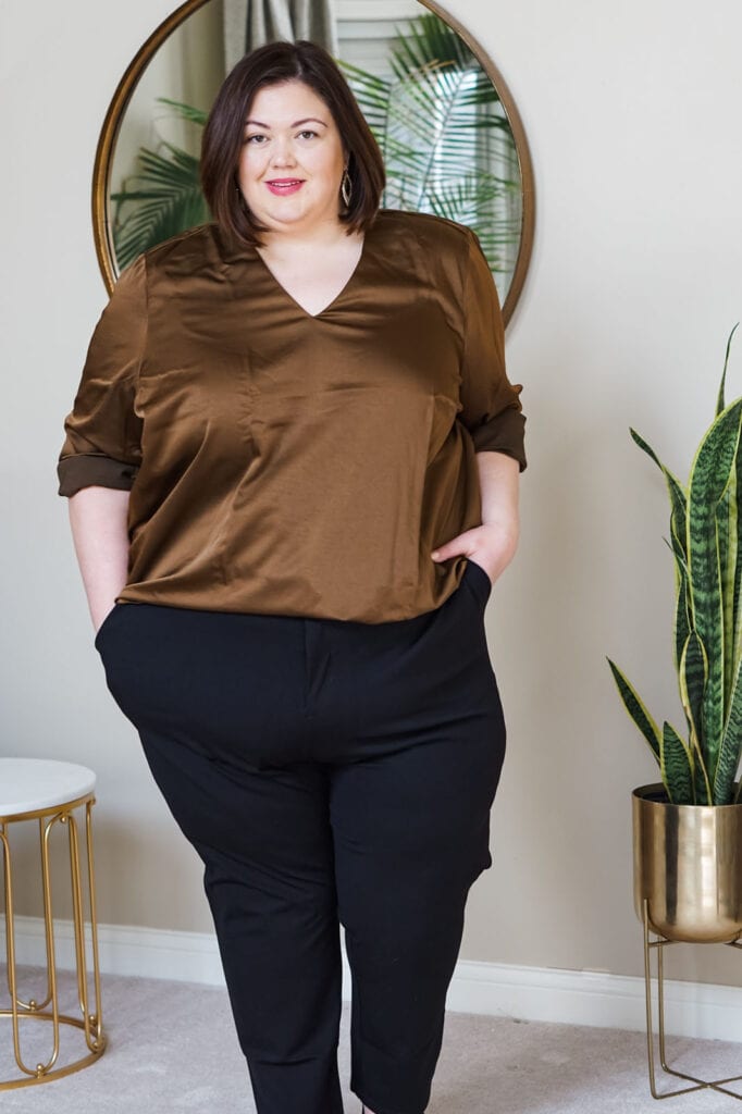 Plus size influencer Authentically Emmie in a satin shirt and trousers from Universal Standard