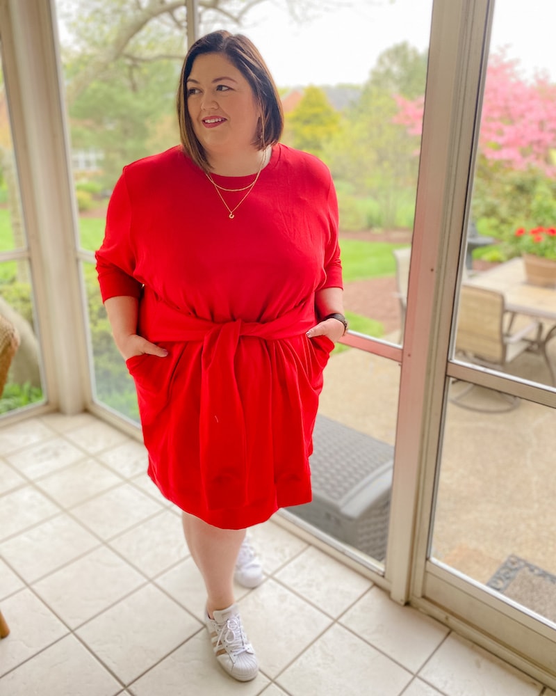 Plus size influencer Emily Ho wears the Universal Standard Misa Dress in red with sneakers